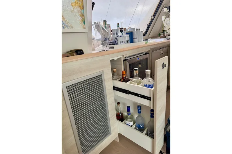 Slide: The Image of Bar area on a 2021 Catana 53 yacht with liquor bottles and glasses. - 44