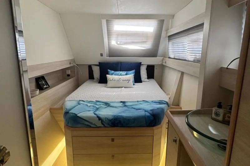 Slide: The Image of Luxurious Catana 53 yacht bedroom interior, 2021 model, featuring modern design and cozy bedding. - 45