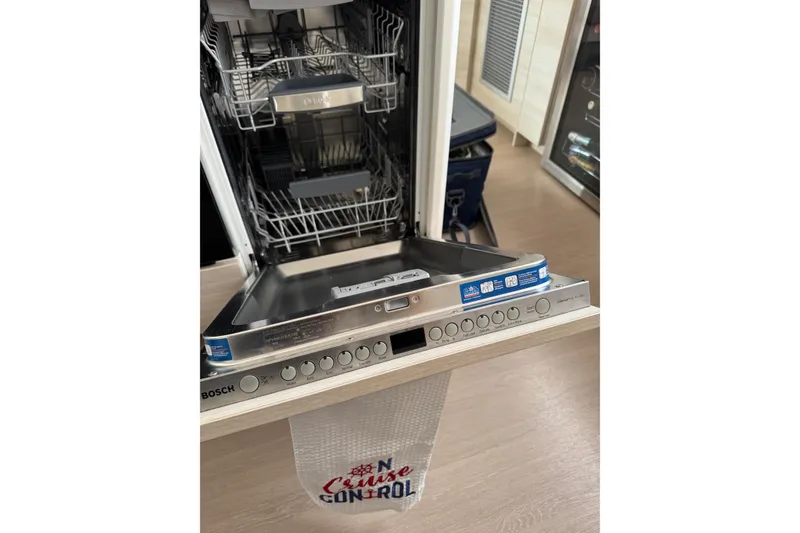 Slide: The Image of Open Bosch dishwasher in a 2021 Catana 53 yacht kitchen setting. - 48
