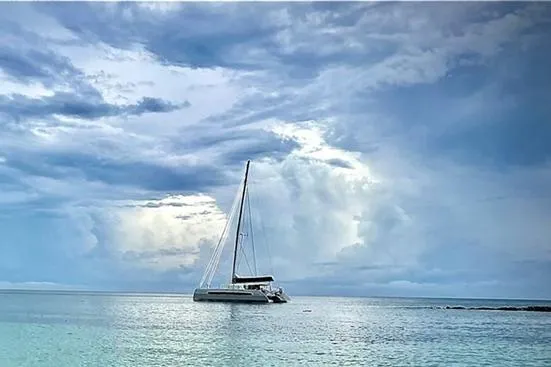 Slide: The Image of Catana 53 catamaran sailing on calm ocean under dramatic cloudy sky, 2021 model. - 5