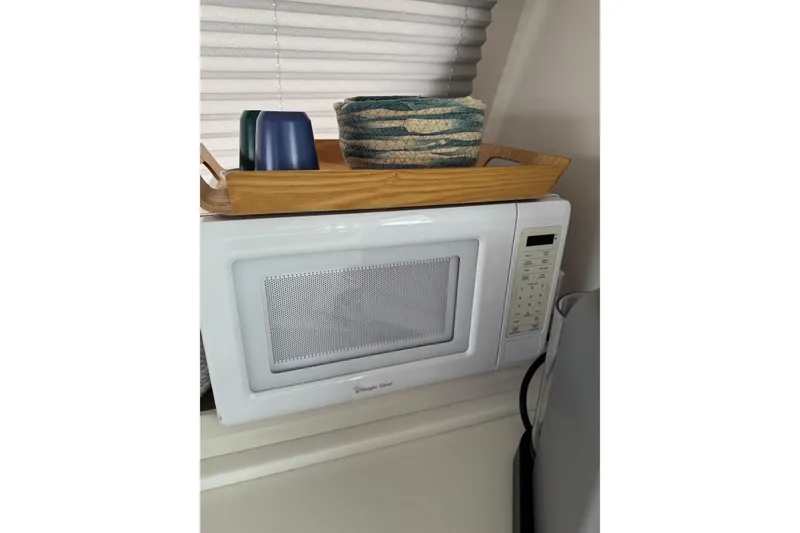 Slide: The Image of Microwave with wooden tray and cups on Catana 53 yacht, 2021 model. - 51