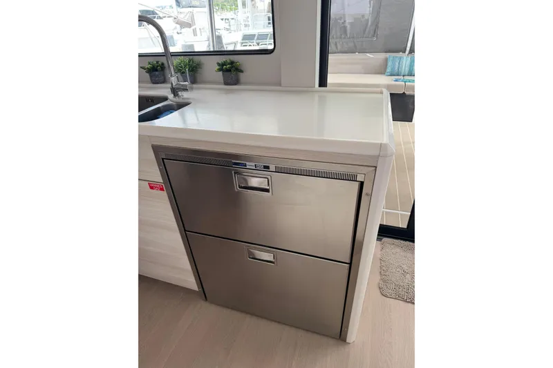 Slide: The Image of Modern kitchen area on a 2021 Catana 53 yacht with stainless steel appliances. - 52