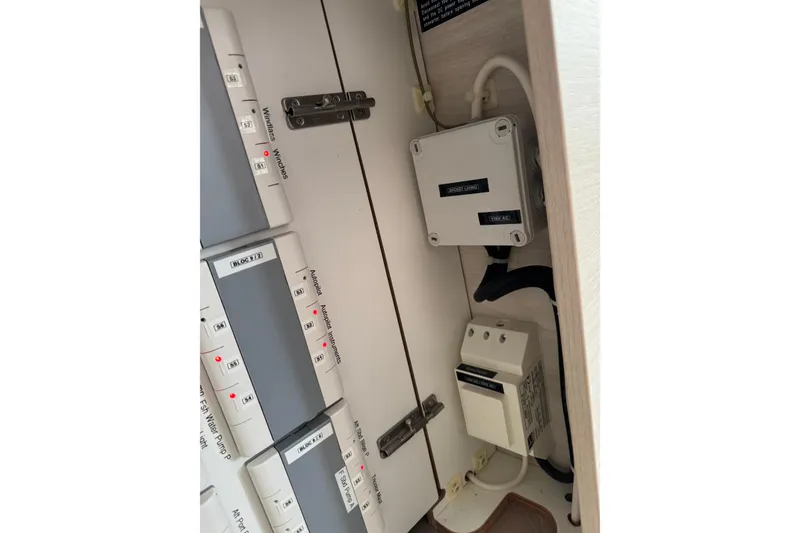 Slide: The Image of Electrical panel inside a 2021 Catana 53 yacht, featuring switches and wiring components. - 56