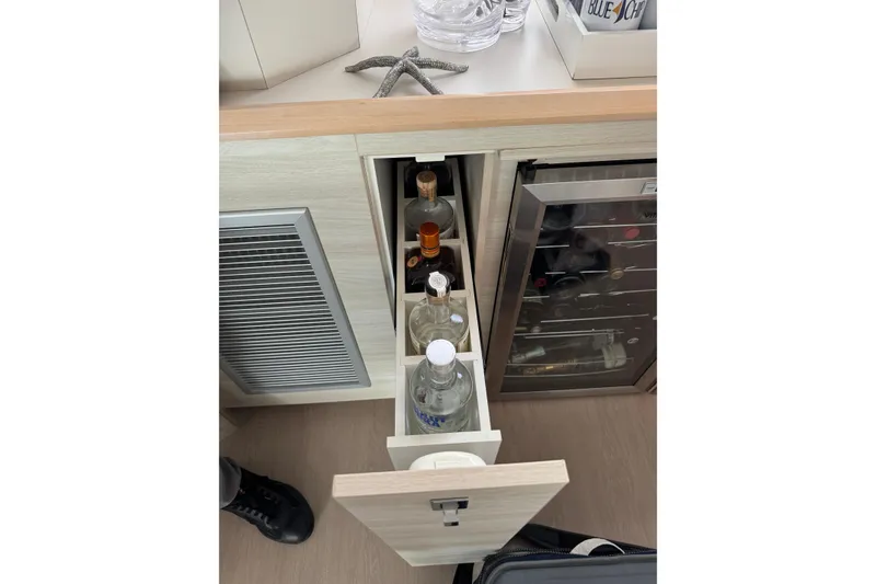 Slide: The Image of Pull-out liquor cabinet and wine fridge in 2021 Catana 53 yacht interior. - 58