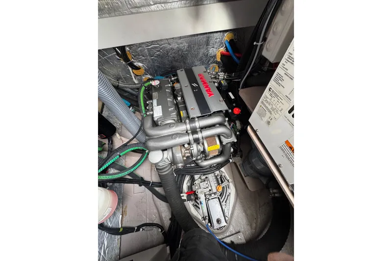Slide: The Image of Engine compartment of a 2021 Catana 53 yacht, featuring a Yanmar engine. - 59