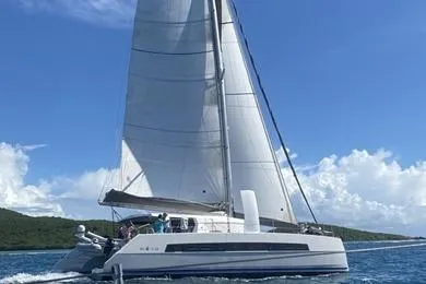 Slide: The Image of 2021 Catana 53 sailing catamaran cruising on open water under clear blue skies. - 6
