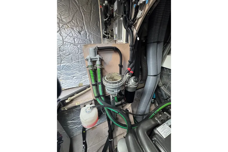Slide: The Image of Engine compartment of a 2021 Catana 53, showcasing hoses and mechanical components. - 60