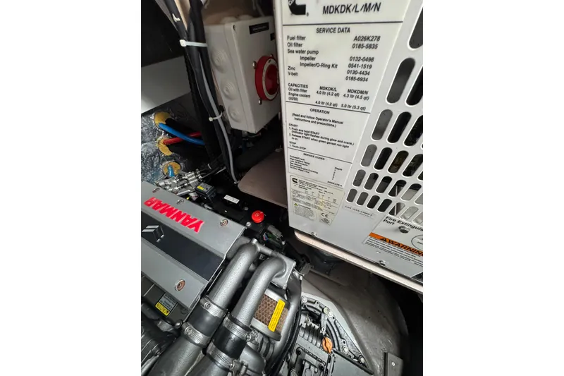 Slide: The Image of Engine compartment of a 2021 Catana 53 yacht featuring Yanmar components and service data. - 62