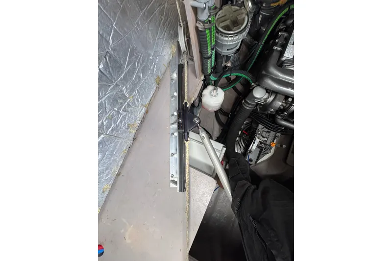 Slide: The Image of Engine compartment of a 2021 Catana 53 yacht, showcasing mechanical components and wiring. - 64