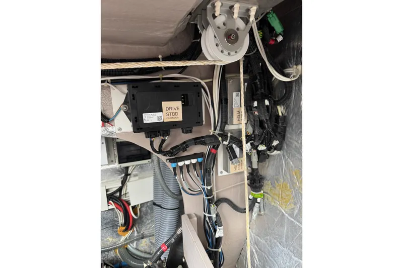 Slide: The Image of Electrical system components inside a 2021 Catana 53 yacht, featuring wiring and control units. - 68