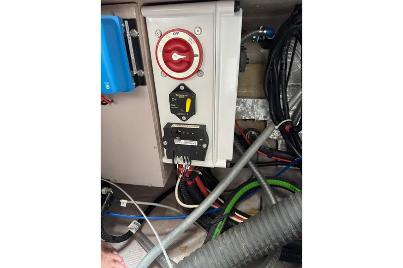 Slide: The Image of Electrical panel in a 2021 Catana 53 yacht, featuring switches and wiring. - 73