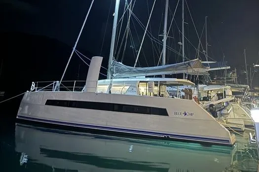 Slide: The Image of 2021 Catana 53 yacht docked at night, illuminated, with sleek design and modern features. - 9