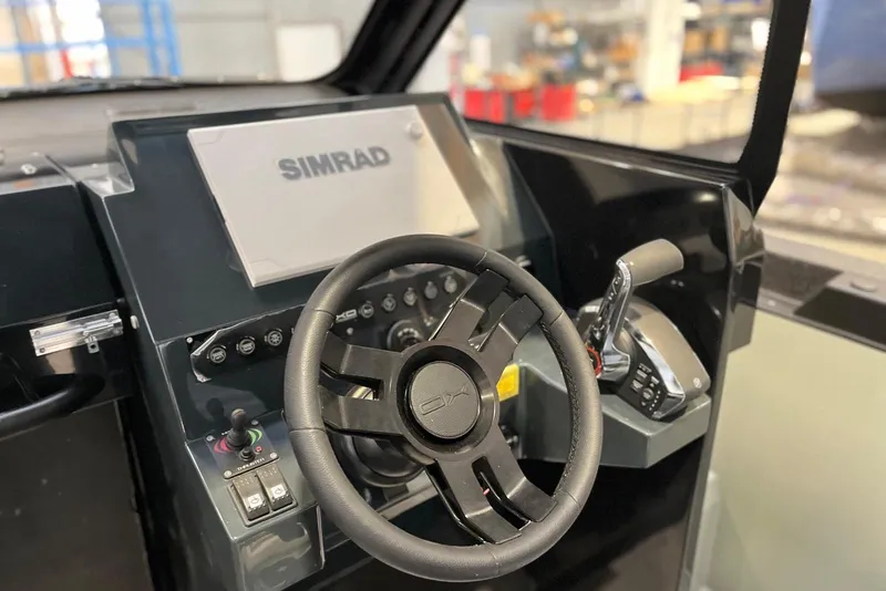 Slide: The Image of Steering console of 2026 XO DFNDR A8 with Simrad navigation system. - 13