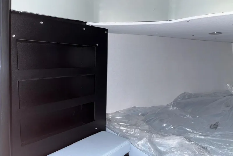 Slide: The Image of Interior of 2026 XO DFNDR A8, featuring sleek black shelving and a covered bed area. - 23