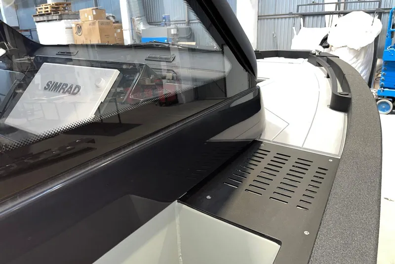 Slide: The Image of 2026 XO DFNDR A8 boat with Simrad navigation system, sleek design, and modern features. - 24