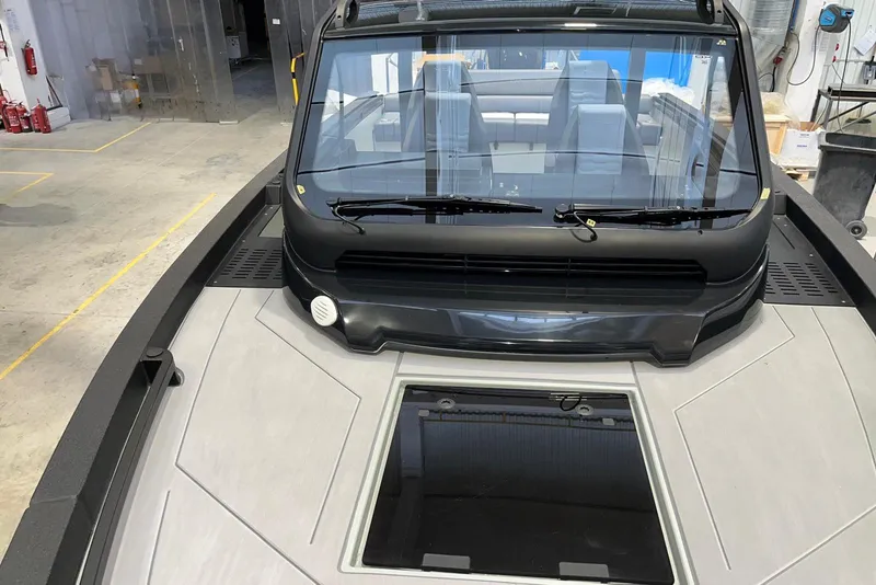 Slide: The Image of 2026 XO DFNDR A8 boat in a workshop, showcasing sleek design and modern features. - 27