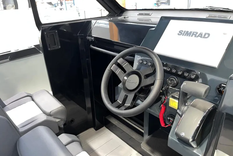 Slide: The Image of Interior cockpit of 2026 XO DFNDR A8 boat with steering wheel and Simrad display. - 29