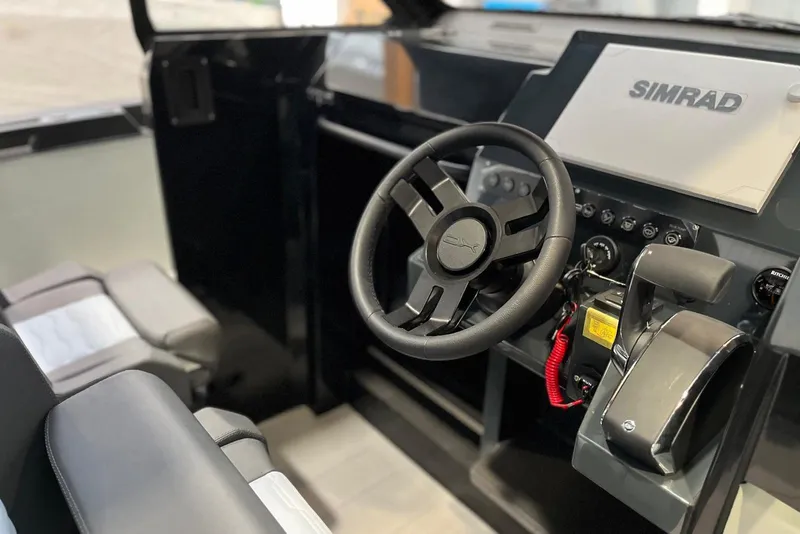 Slide: The Image of Interior cockpit of 2026 XO DFNDR A8 boat with steering wheel and Simrad display. - 30