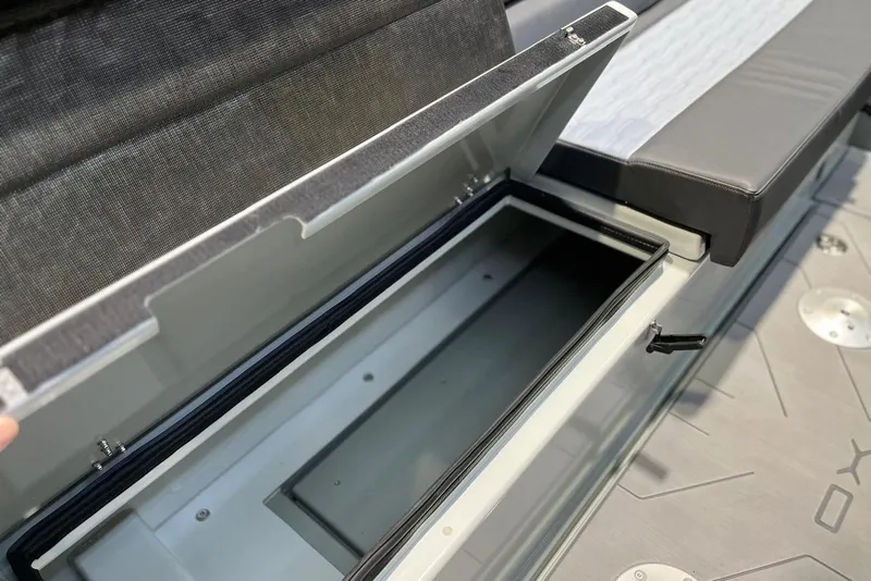 Slide: The Image of Open storage compartment in 2026 XO DFNDR A8 boat, showcasing sleek interior design. - 32