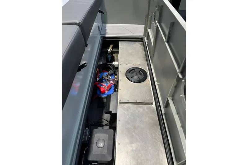 Slide: The Image of Interior view of 2026 XO DFNDR A8 boat, showcasing storage compartment and wiring. - 35