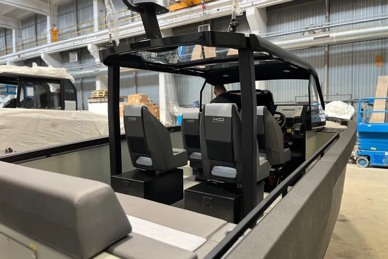 Slide: The Image of Interior view of 2026 XO DFNDR A8 boat in a warehouse setting. - 4