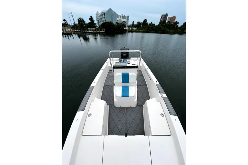 Slide: The Image of 2004 Pathfinder 2200 V boat on calm water, featuring sleek design and modern seating. - 3