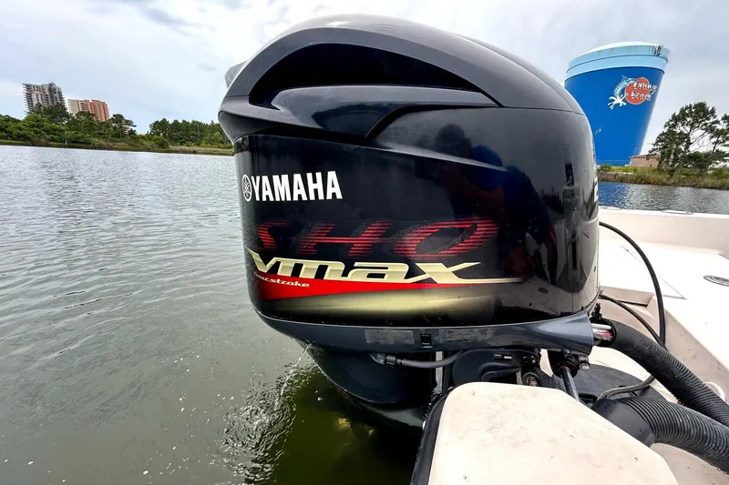 Slide: The Image of Yamaha VMAX outboard motor on a 2004 Pathfinder 2200 V boat in a scenic waterway. - 6