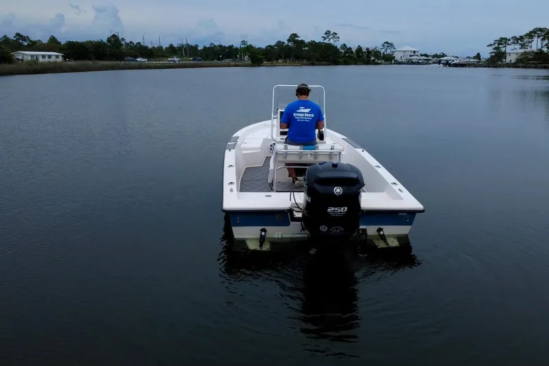 Slide: The Image of 2004 Pathfinder 2200 V boat on calm water, rear view with outboard motor. - 7