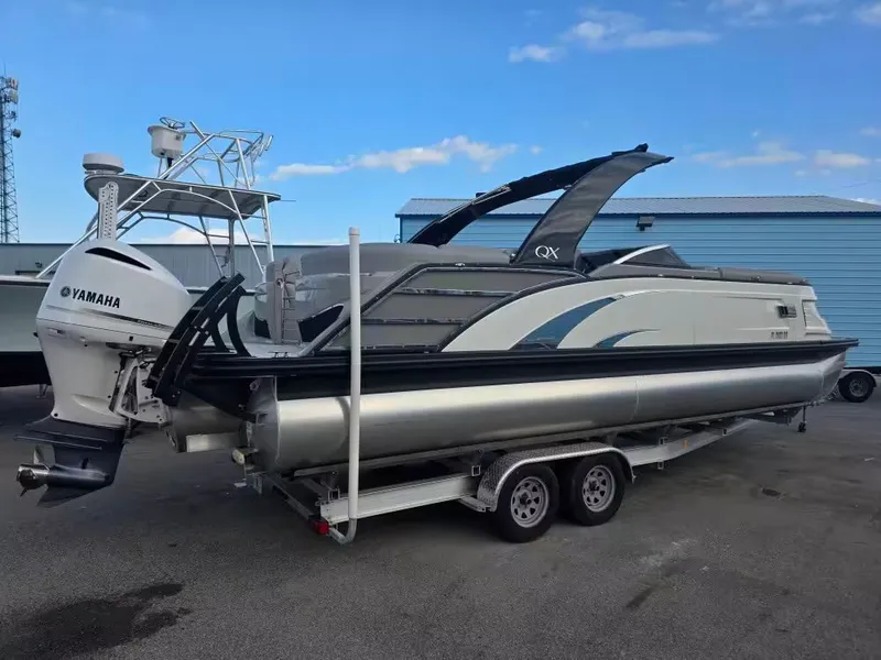 Slide: The Image of 2020 Bennington 25QXFB pontoon boat with Yamaha engine on trailer. - 2