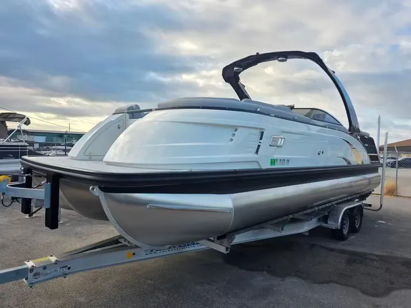 Slide: The Image of 2020 Bennington 25QXFB pontoon boat on trailer at sunset. - 3