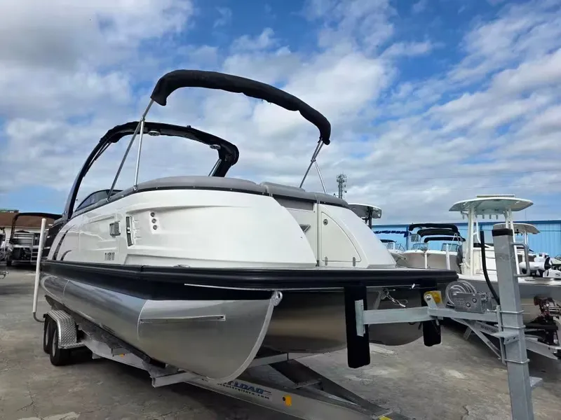 Slide: The Image of 2020 Bennington 25QXFB boat on trailer under blue sky. - 5