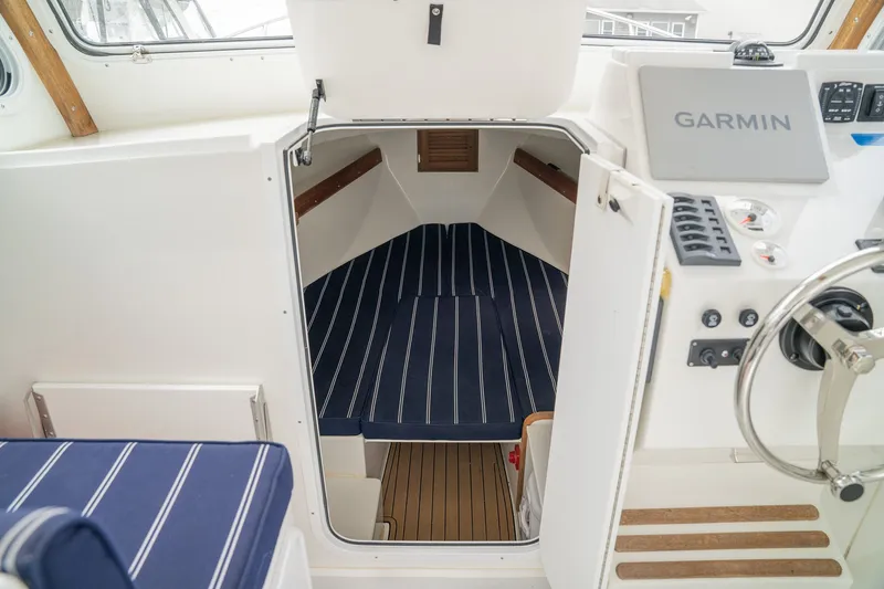 Slide: The Image of Interior of Eastern 248 Explorer boat, 2022 model, featuring Garmin controls. - 10