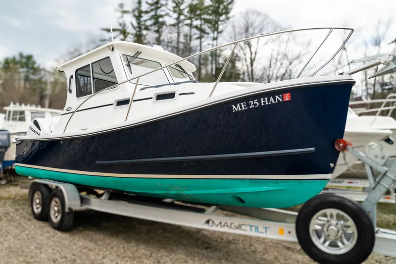 Slide: The Image of 2022 Eastern 248 Explorer boat on trailer outdoors. - 3