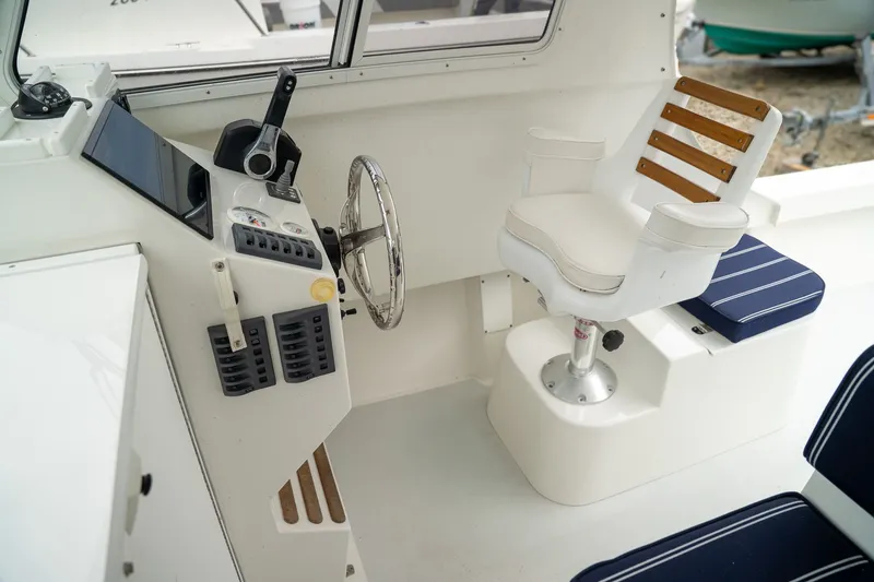 Slide: The Image of Interior of 2022 Eastern 248 Explorer with helm and seating. - 8
