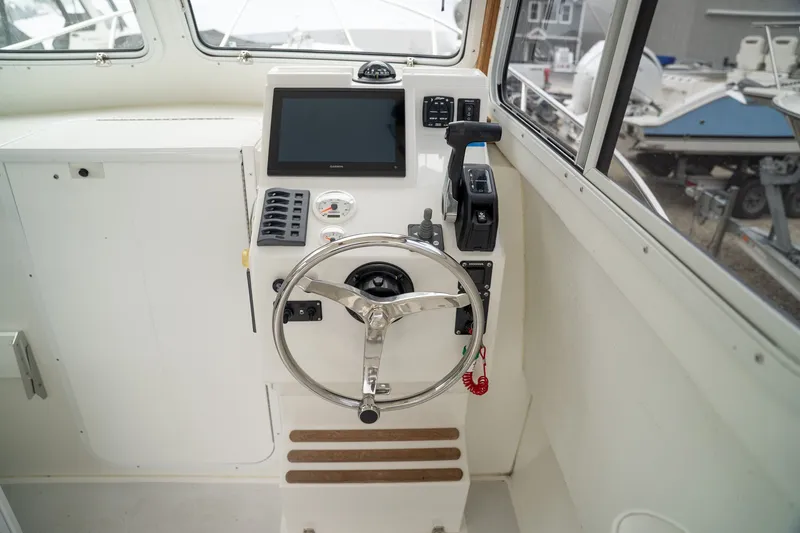 Slide: The Image of 2022 Eastern 248 Explorer helm with modern navigation system. - 9