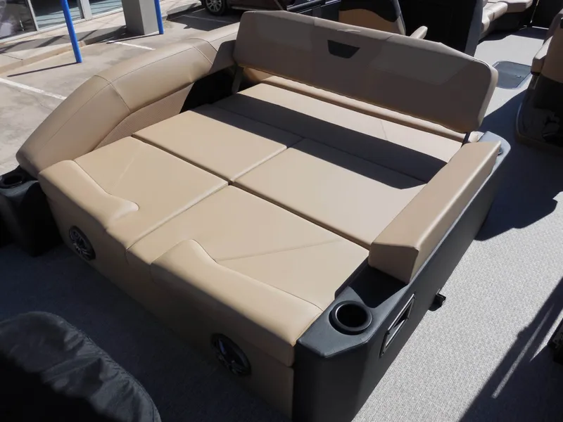 Slide: The Image of The image shows a beige lounging area on a boat with cup holders on the sides. - 20