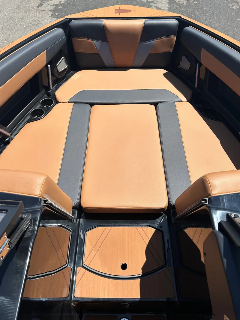 Slide: The Image of Interior of Axis T250 boat, 2026, featuring brown and gray upholstery. - 13