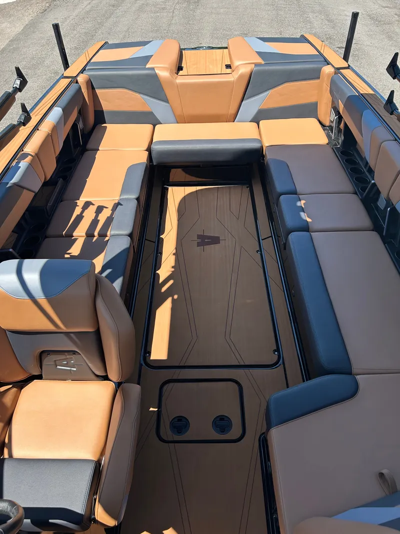 Slide: The Image of Interior of Axis T250 boat, 2026 model, featuring brown and gray seating. - 16
