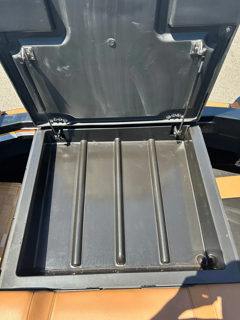 Slide: The Image of Open storage compartment lid of a 2026 Axis T250. - 19
