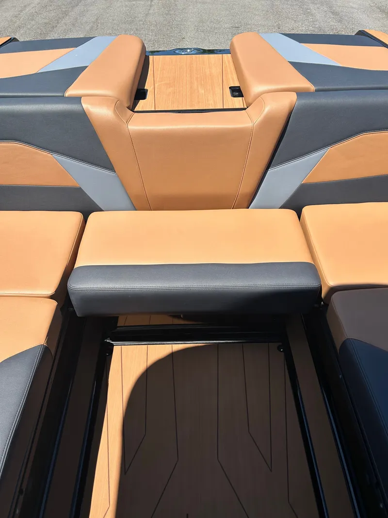 Slide: The Image of Interior of Axis T250 boat, 2026 model, featuring brown and gray seating. - 8
