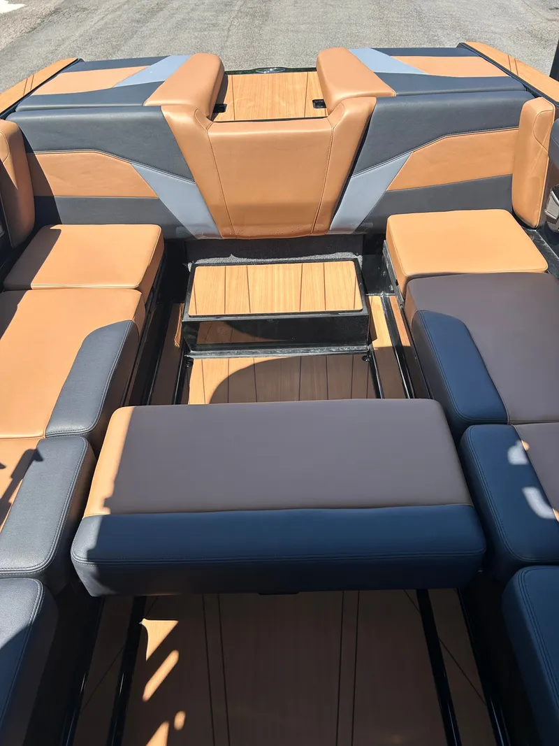 Slide: The Image of Interior of Axis T250 boat, 2026, featuring brown and gray seating. - 9