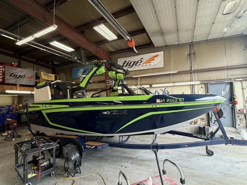 The Image of 2020 Tigé 23ZX boat in a workshop, painted blue and green. - 0