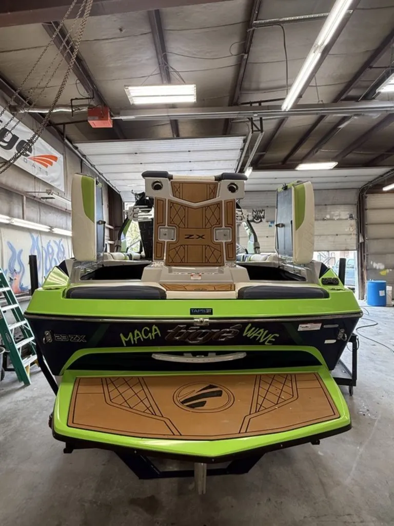 Slide: The Image of 2020 Tigé 23ZX boat in a workshop, green and black. - 8