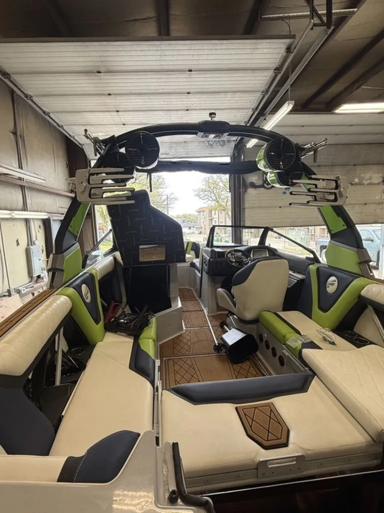 Slide: The Image of Interior view of a 2020 Tigé 23ZX boat in a garage. - 9