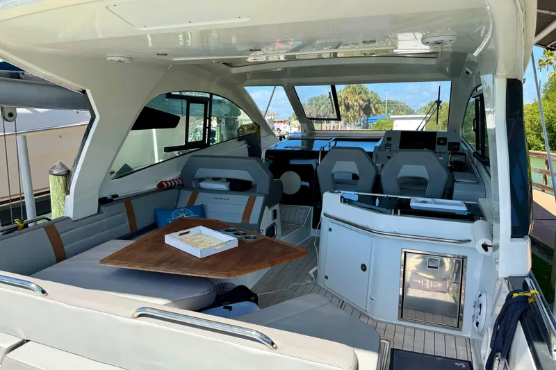 Slide: The Image of Interior view of 2024 Beneteau Gran Turismo 32 yacht, featuring seating and helm station. - 11