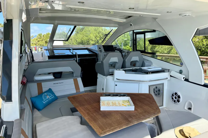 Slide: The Image of Interior of 2024 Beneteau Gran Turismo 32 yacht, featuring modern seating and helm area. - 12