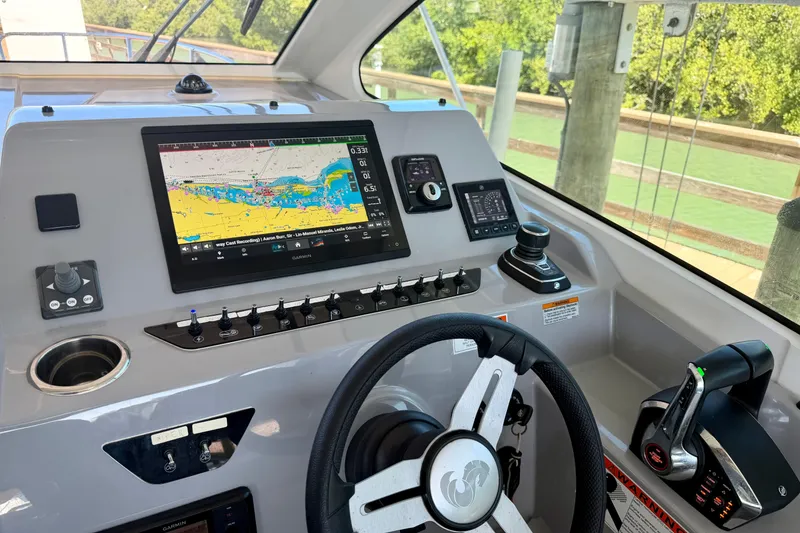Slide: The Image of 2024 Beneteau Gran Turismo 32 helm with advanced navigation system and controls. - 15