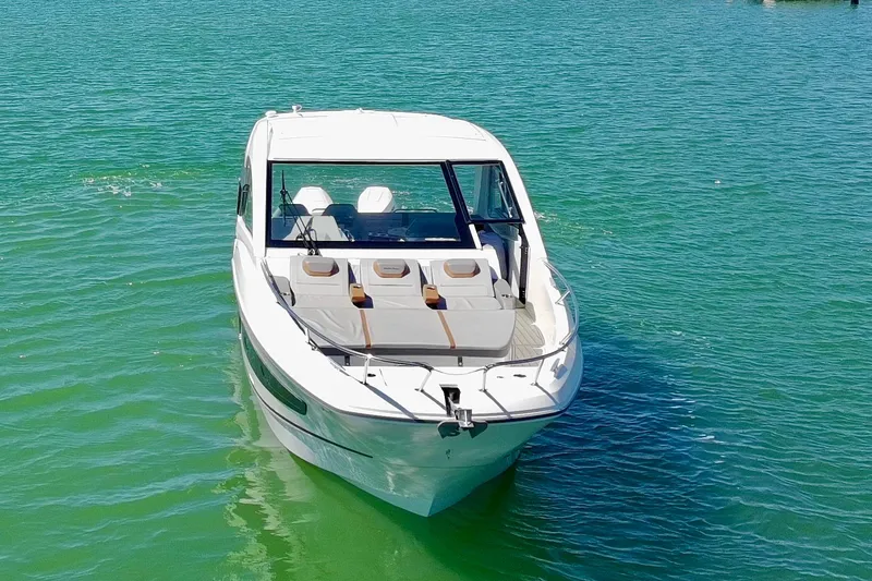 Slide: The Image of 2024 Beneteau Gran Turismo 32 yacht on clear turquoise water. - 2