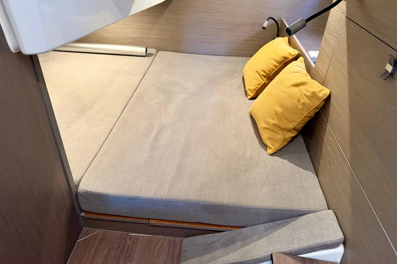 Slide: The Image of Interior cabin of 2024 Beneteau Gran Turismo 32 with cozy bedding and yellow pillows. - 25