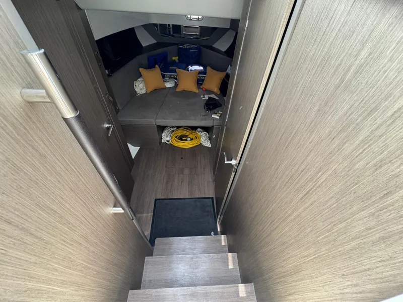 Slide: The Image of Interior cabin of 2024 Beneteau Gran Turismo 32 with wooden stairs and cozy seating area. - 27